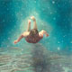 Painting of a man swimming underwater.