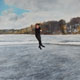 Painting of figure skater on frozen pond.