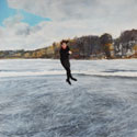 Painting of figure skater on pond ice mid-jump. (thumb)