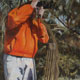Painting of hunter in orange jacket with longbow